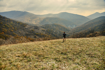 Fototapeta na wymiar Woman walking in autumn mountains