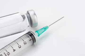 medical ampoules and syringe on white background