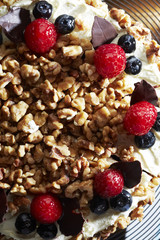 Walnuts and berries decoration on cake,close up