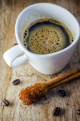 Sugar Stick Cinnamon and cup of coffee on wooden table