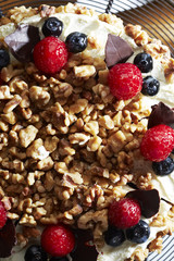 Walnuts and berries decoration on cake,close up