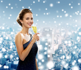 smiling woman holding glass of sparkling wine