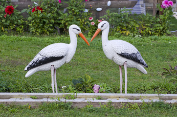 funny two white stork decorations in resort park