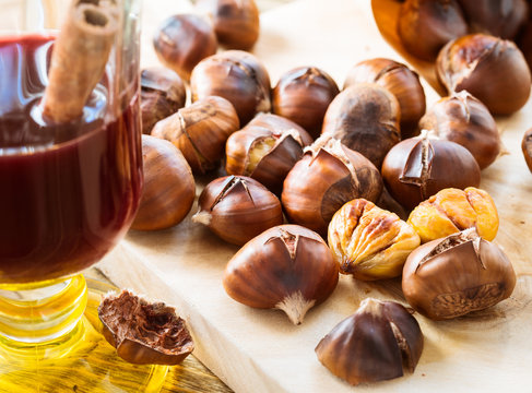 Delicious roasted chestnuts on wooden board