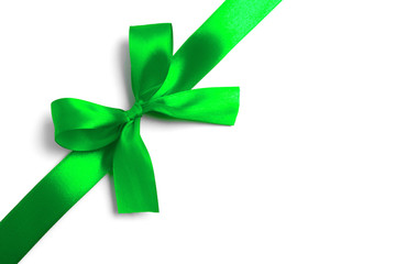 Shiny green satin ribbon on white background