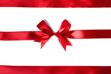 Shiny red satin ribbon on white background