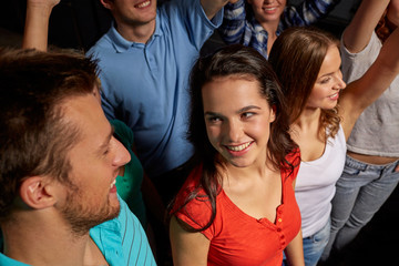 smiling friends at concert in club