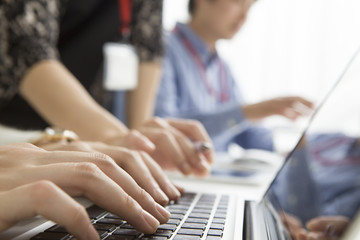 Hands of women who are entering the laptop