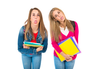 Students doing a joke over isolated white background