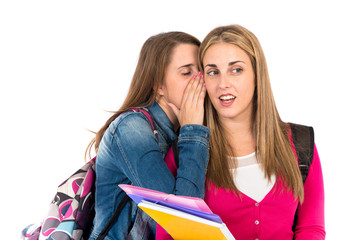 Student women whispering over white background