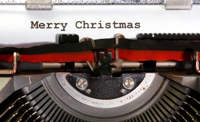 MERRY CHRISTMAS written with black ink with the typewriter