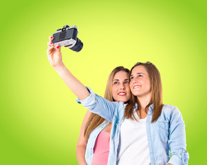 Girl photographing over green background