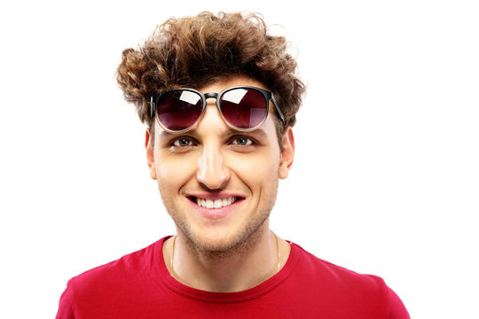 Happy fashion man with sunglasses over white background