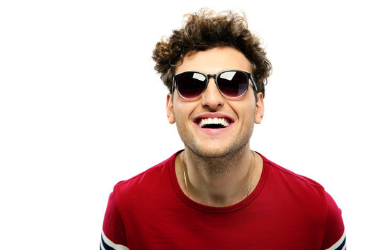 Laughing Young Fashion Man With Sunglasses On A White Backgorund