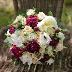 Wedding bouquet of white and pink roses and peonies