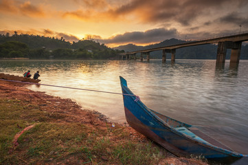 Sunrise at Banding Island and unknown men having a bath.