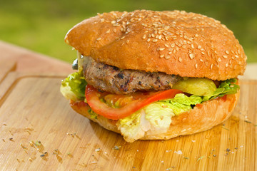 Tasty burger with melted cheese and thick succulent ground beef