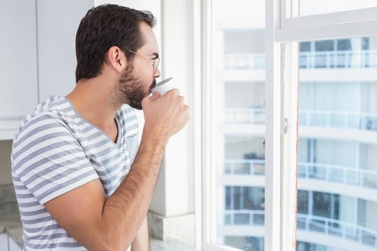 Young Man Looking Out His Window