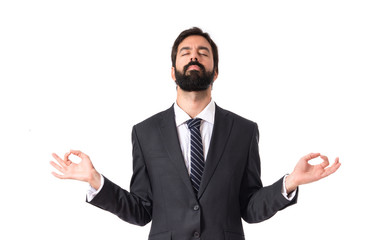 Businessman in zen position over white background