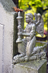 angel with candlestick in old cemetery
