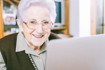 Fototapeta na wymiar Senior woman with laptop at home