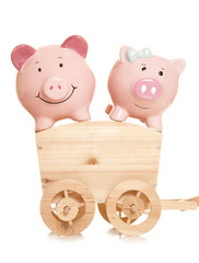 two piggybanks on a wooden cart