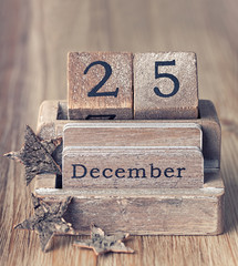 Old vintage wooden calendar set on the 25 of December with chris