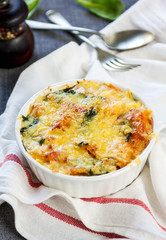Baked pasta with spinach in tomato sauce