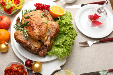 Baked chicken for festive dinner. Christmas table setting