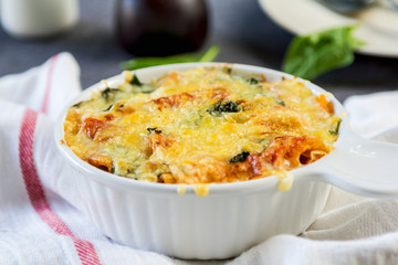 Baked pasta with spinach in tomato sauce