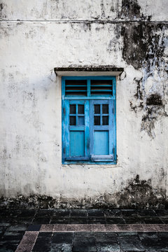 Blue wooden window and grunge wall