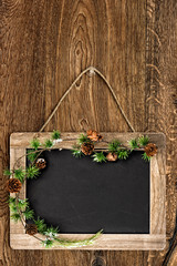 blackboard with christmas tree branch decoration