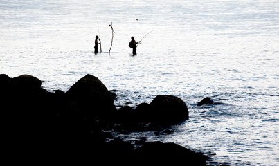 Fishing spinning in the sea. Silhouette of a fishermans
