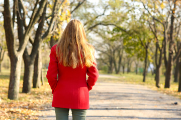Lonely woman walking in park