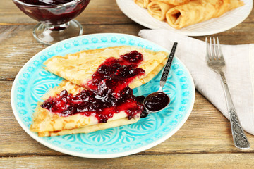 Plate of delicious pancakes with berry jam