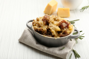 Pasta baked with vegetables and cheese in ceramic pot