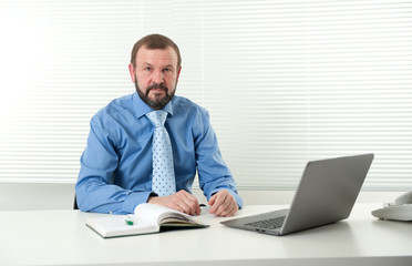 mature businessman working on his laptop