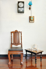 Antique wood chair and tea set on wooden floor