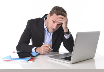 businessman working in stress at laptop suffering headache