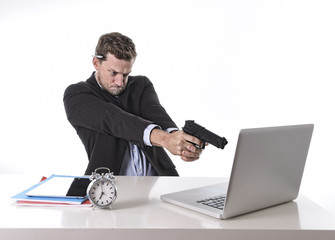 businessman pointing gun to computer in overwork overtime work
