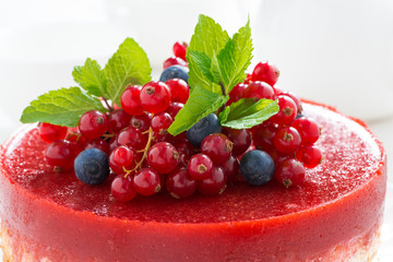 cheesecake with berry jelly on a plate, close-up