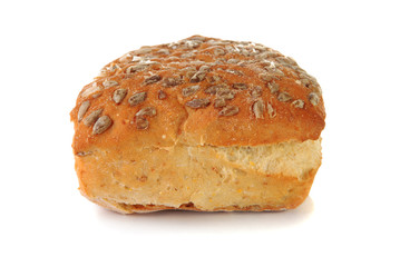 Close-up of a bun with sunflower seeds on white background