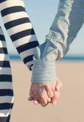 Closeup of couple holding hands