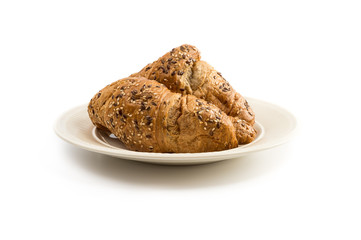 Two croissants on an off-white plate