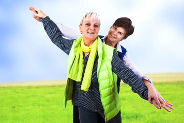 Two women adhere to the outstretched hands