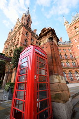 Fototapeta na wymiar Red telephone box with Kings Cross Station, London