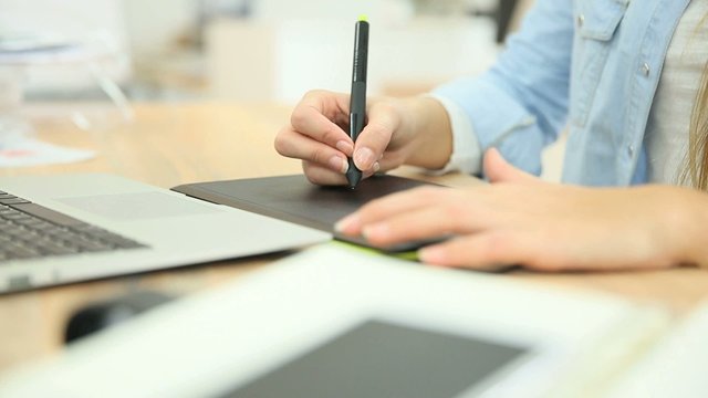 Closeup of hand working on graphic tablet