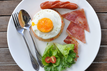 Tomato fried rice with sausage, hams and egg on wooden table. TO