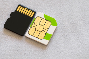 A micros SIM next to a micro SD card