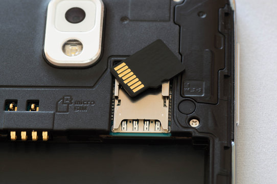 Upper shot of a dismantled smartphone with SD card